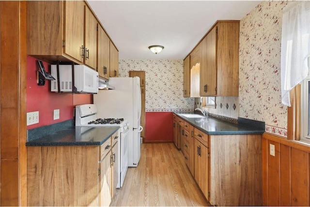 8029 2nd Ave S, Bloomington, MN 55420 - kitchen with wallpapered walls, white appliances, light wood-type flooring, under cabinet range hood, and dark countertops