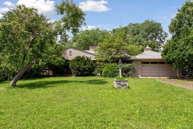 1065 Colby St, Saint Paul, MN 55116 - view of grassy yard featuring a garage and driveway