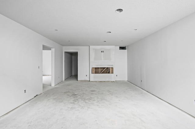 201 Mccarrons Pl W, Roseville, MN 55113 - unfurnished living room with a fireplace and unfinished concrete flooring