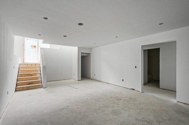 201 Mccarrons Pl W, Roseville, MN 55113 - unfurnished room featuring concrete floors, stairs, and a textured ceiling