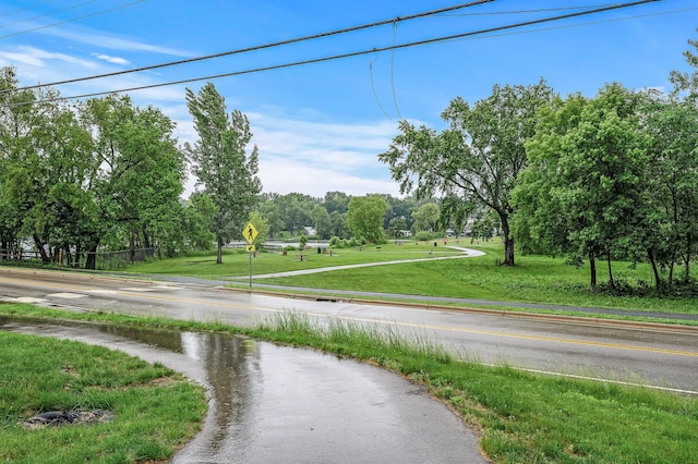 201 Mccarrons Pl W, Roseville, MN 55113 - view of asphalt road with view of scattered trees and traffic signs