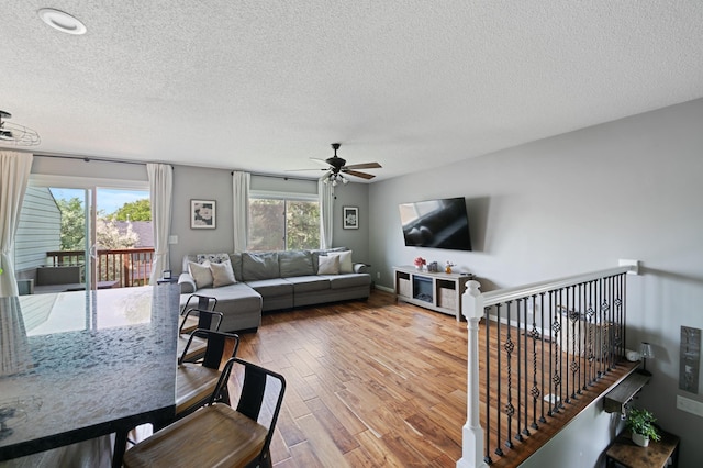 3576 Avon Ct, Woodbury, MN 55125 - living area with a ceiling fan, a textured ceiling, and wood finished floors