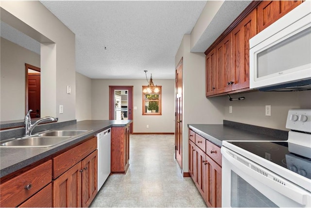 641 Lake St N, Big Lake, MN 55309 - kitchen featuring white appliances, dark countertops, brown cabinets, light flooring, and a textured ceiling