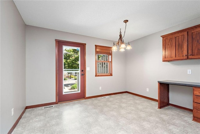 641 Lake St N, Big Lake, MN 55309 - unfurnished dining area featuring a chandelier and light flooring