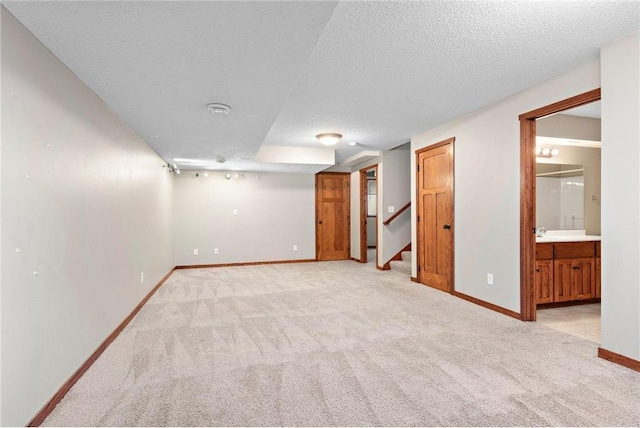 641 Lake St N, Big Lake, MN 55309 - finished below grade area featuring light carpet, a textured ceiling, and stairway