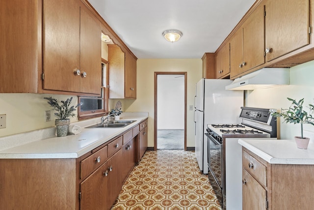 6112 Kyle Ave N, Brooklyn Center, MN 55429 - kitchen featuring gas range, under cabinet range hood, light countertops, and brown cabinetry