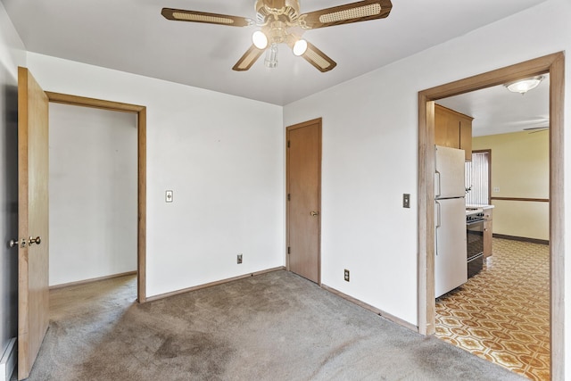 6112 Kyle Ave N, Brooklyn Center, MN 55429 - unfurnished bedroom featuring freestanding refrigerator, light carpet, and ceiling fan
