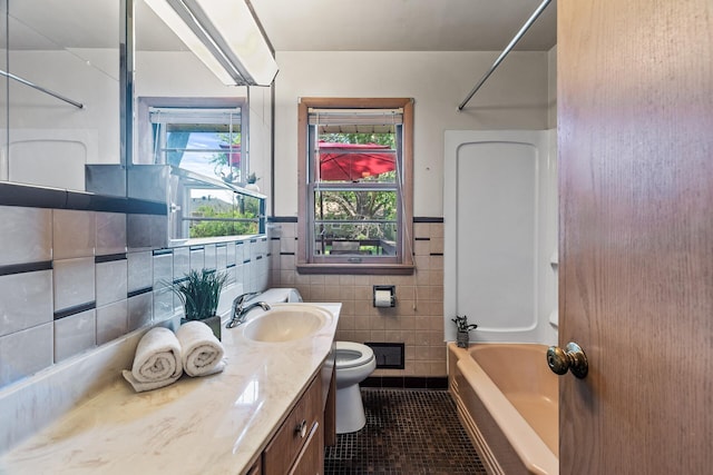 6112 Kyle Ave N, Brooklyn Center, MN 55429 - full bath with tile patterned floors, tile walls, vanity, shower / tub combination, and wainscoting