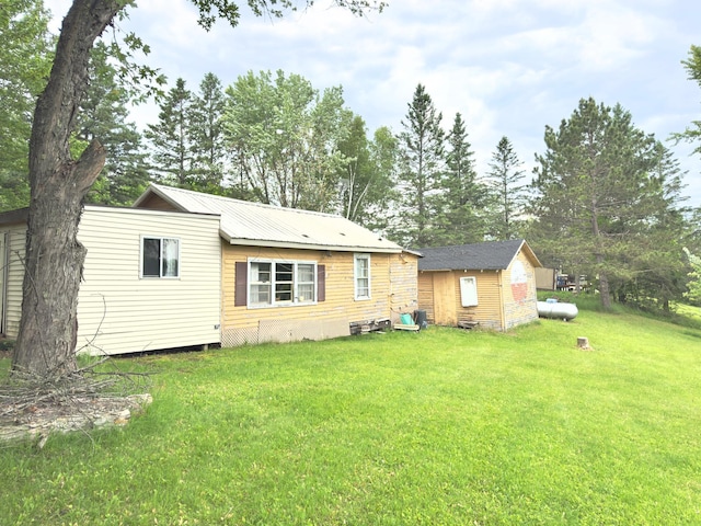 92354 Lake 12 Rd, Windemere Twp, MN 55783 - back of house featuring a yard and view of scattered trees