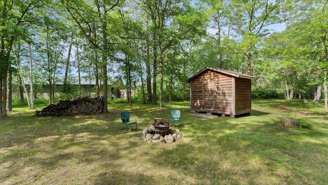 1764 State 84 SW, Pine River, MN 56474 - view of green lawn featuring a fire pit and a storage unit