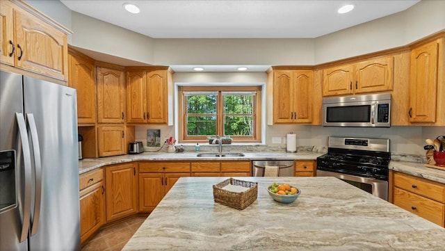 1764 State 84 SW, Pine River, MN 56474 - kitchen with appliances with stainless steel finishes, light stone countertops, tile patterned flooring, recessed lighting, and brown cabinets