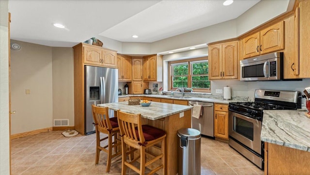 1764 State 84 SW, Pine River, MN 56474 - kitchen with stainless steel appliances, light stone countertops, a breakfast bar area, a center island, and recessed lighting
