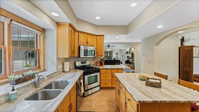 1764 State 84 SW, Pine River, MN 56474 - kitchen featuring arched walkways, appliances with stainless steel finishes, healthy amount of natural light, a center island, and recessed lighting