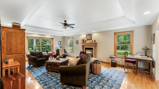 1764 State 84 SW, Pine River, MN 56474 - living room featuring a raised ceiling, healthy amount of natural light, ceiling fan, and light wood-type flooring