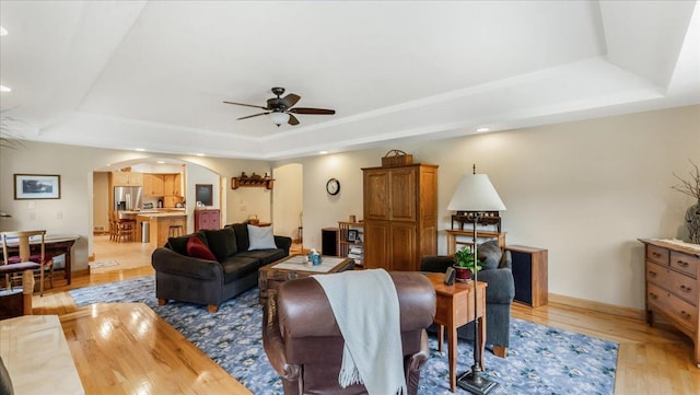 1764 State 84 SW, Pine River, MN 56474 - living room featuring a raised ceiling, arched walkways, ceiling fan, light wood-type flooring, and recessed lighting