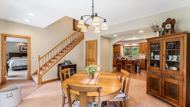 1764 State 84 SW, Pine River, MN 56474 - dining space featuring arched walkways, light carpet, recessed lighting, a chandelier, and stairway