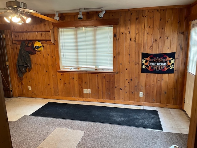 1764 State 84 SW, Pine River, MN 56474 - empty room featuring track lighting, a ceiling fan, wooden walls, and tile patterned floors