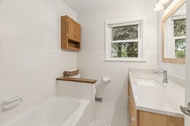755 Keokuk Ln, Mendota Heights, MN 55120 - bathroom featuring a garden tub, vanity, healthy amount of natural light, tile patterned flooring, and a wainscoted wall