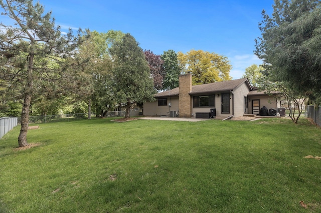 755 Keokuk Ln, Mendota Heights, MN 55120 - rear view of house featuring a chimney, a patio area, a fenced backyard, and roof with shingles
