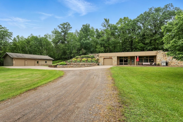 2454 230th Ave, Whited Twp, MN 55007 - view of front facade with driveway, stone siding, a front lawn, and a garage