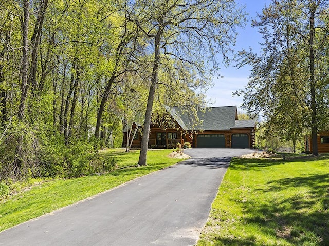 25533 Heritage Ln, Wyoming, MN 55092 - log home with a garage, asphalt driveway, a front yard, and log exterior