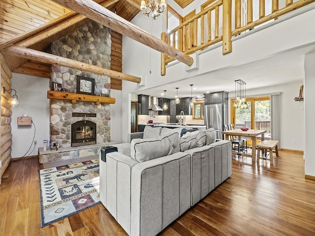25533 Heritage Ln, Wyoming, MN 55092 - living room with a chandelier, hardwood / wood-style floors, a stone fireplace, a wooden ceiling with exposed beams, and high vaulted ceiling
