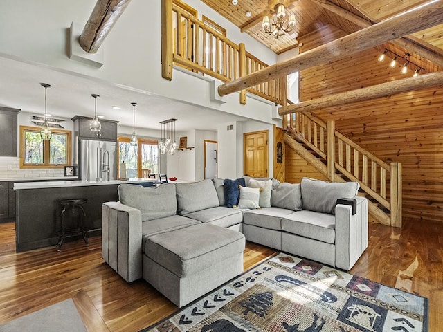 25533 Heritage Ln, Wyoming, MN 55092 - living area with hardwood / wood-style flooring, stairway, a chandelier, a wood ceiling with exposed beams, and a towering ceiling