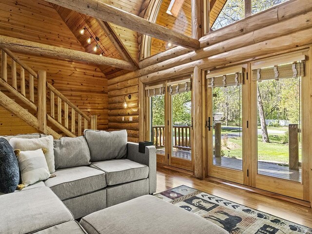 25533 Heritage Ln, Wyoming, MN 55092 - living room featuring hardwood / wood-style floors, a wooden ceiling with exposed beams, high vaulted ceiling, rustic walls, and stairway