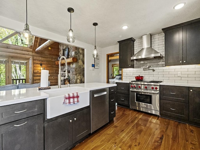25533 Heritage Ln, Wyoming, MN 55092 - kitchen with stainless steel appliances, wall chimney range hood, rustic walls, dark wood-style floors, and light countertops