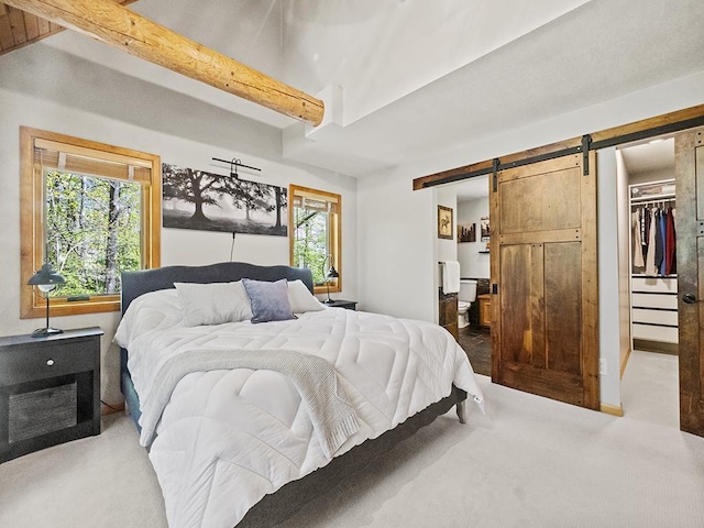 25533 Heritage Ln, Wyoming, MN 55092 - carpeted bedroom with a barn door, a spacious closet, beam ceiling, ensuite bathroom, and a closet