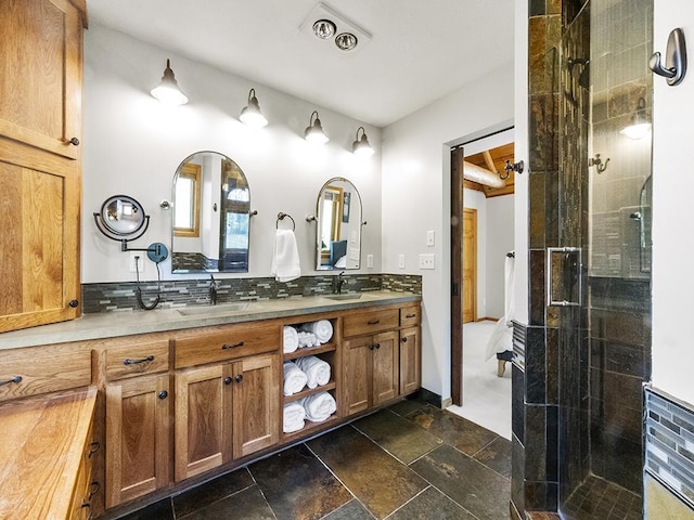 25533 Heritage Ln, Wyoming, MN 55092 - bathroom featuring double vanity, a stall shower, backsplash, and stone tile flooring