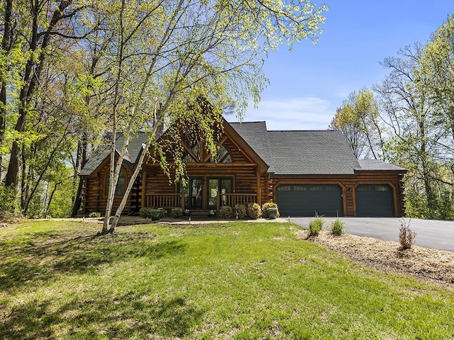 25533 Heritage Ln, Wyoming, MN 55092 - log home with log exterior, a garage, a front yard, driveway, and a shingled roof
