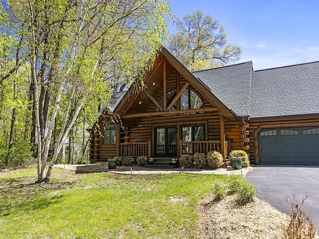 25533 Heritage Ln, Wyoming, MN 55092 - log-style house featuring log exterior, french doors, a shingled roof, a garage, and driveway