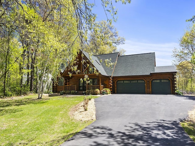 25533 Heritage Ln, Wyoming, MN 55092 - log cabin featuring log siding, an attached garage, covered porch, and driveway