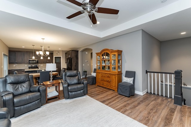 2745 Sand Trap Rd SE, Rochester, MN 55904 - living area with arched walkways, wood finished floors, a ceiling fan, a chandelier, and recessed lighting