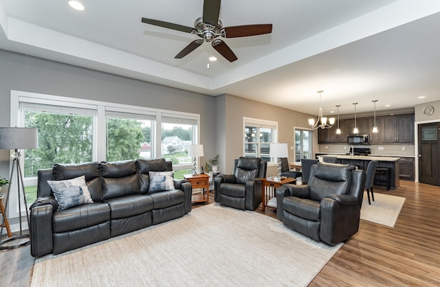 2745 Sand Trap Rd SE, Rochester, MN 55904 - living room featuring a chandelier, wood finished floors, ceiling fan, recessed lighting, and a raised ceiling