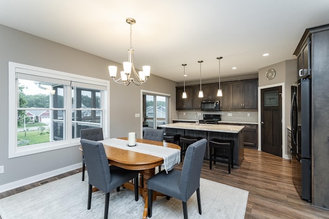 2745 Sand Trap Rd SE, Rochester, MN 55904 - dining area featuring a chandelier, plenty of natural light, dark wood-style flooring, and recessed lighting