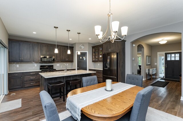 2745 Sand Trap Rd SE, Rochester, MN 55904 - dining space with arched walkways, dark wood-style floors, a chandelier, and recessed lighting