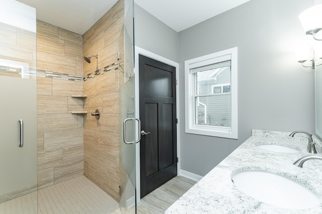 2745 Sand Trap Rd SE, Rochester, MN 55904 - bathroom with a stall shower, double vanity, and wood finished floors