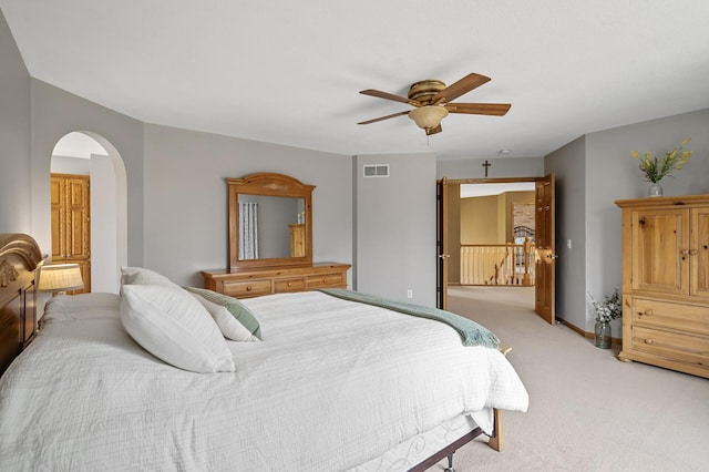 8051 Enclave Bay, Woodbury, MN 55125 - bedroom featuring light carpet, arched walkways, and ceiling fan
