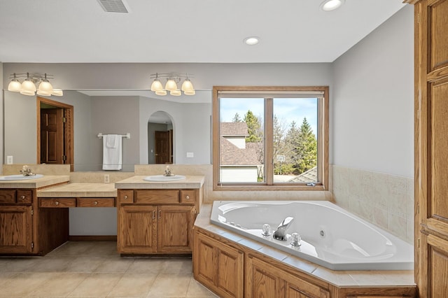 8051 Enclave Bay, Woodbury, MN 55125 - bathroom featuring double vanity, a tub with jets, tile patterned floors, and recessed lighting