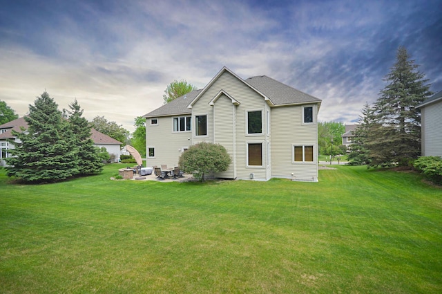 8051 Enclave Bay, Woodbury, MN 55125 - rear view of property featuring a lawn and a patio
