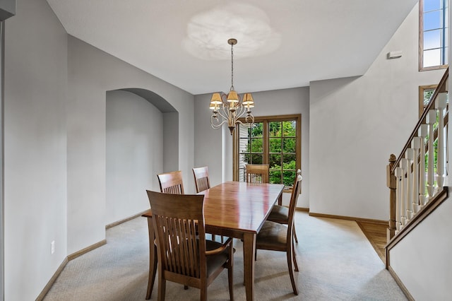 8051 Enclave Bay, Woodbury, MN 55125 - dining space featuring light carpet, arched walkways, and healthy amount of natural light