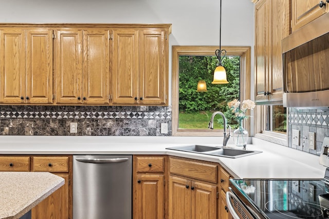 8051 Enclave Bay, Woodbury, MN 55125 - kitchen with appliances with stainless steel finishes, tasteful backsplash, light countertops, and hanging light fixtures