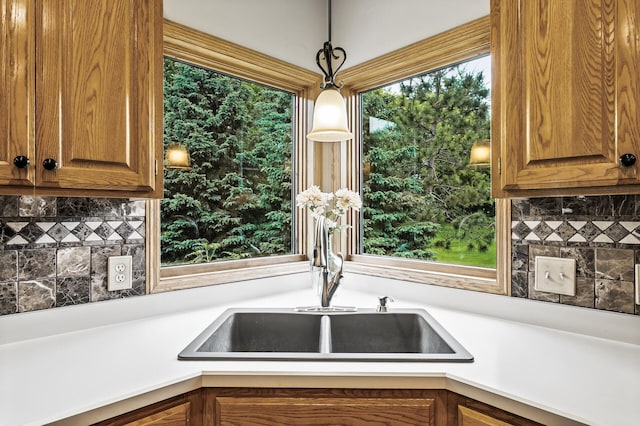 8051 Enclave Bay, Woodbury, MN 55125 - kitchen featuring decorative backsplash, decorative light fixtures, brown cabinets, and light countertops