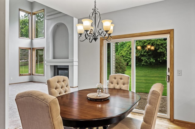 8051 Enclave Bay, Woodbury, MN 55125 - dining room featuring a chandelier, healthy amount of natural light, and a fireplace