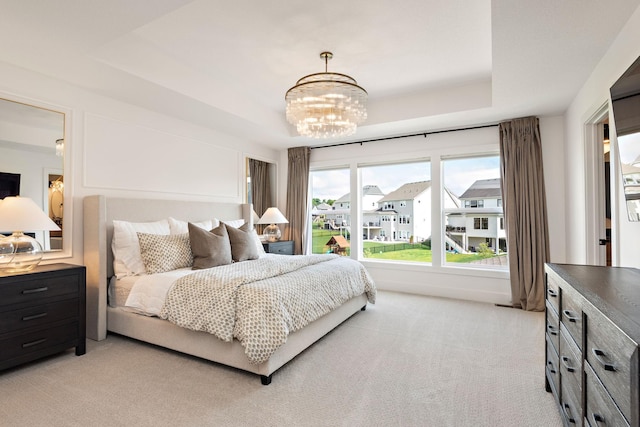 16942 47th Pl N, Plymouth, MN 55446 - bedroom featuring a chandelier, a raised ceiling, and light colored carpet