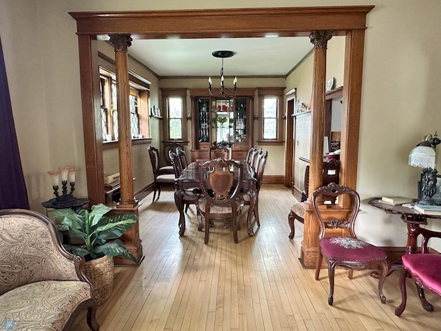 619 University Dr S, Fargo, ND 58103 - dining room with light wood-type flooring, ornate columns, and ornamental molding