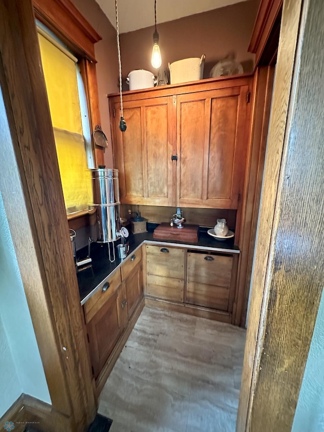 619 University Dr S, Fargo, ND 58103 - kitchen featuring dark countertops, brown cabinets, and hanging light fixtures
