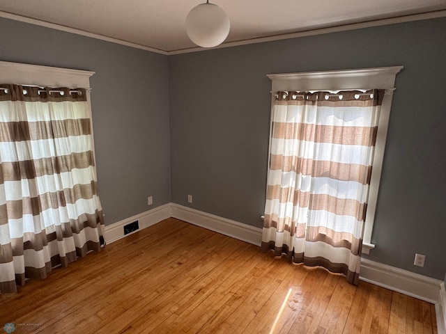 619 University Dr S, Fargo, ND 58103 - spare room featuring wood-type flooring and crown molding
